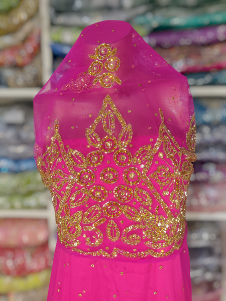 Gold Design on Dark Pink Background Handwork George